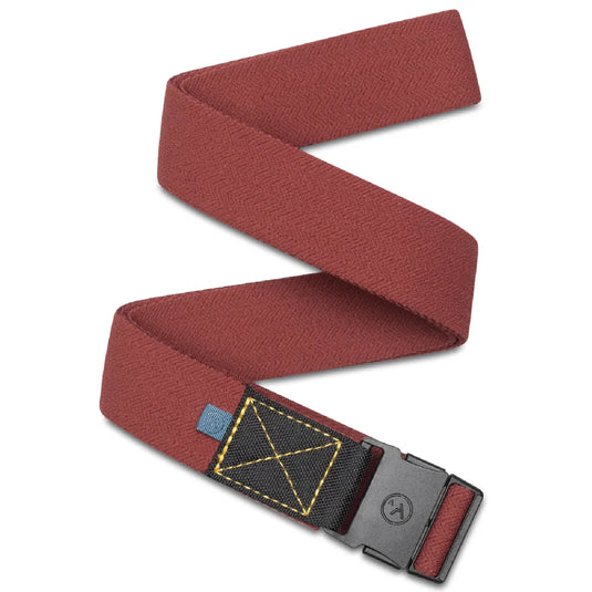 A slim red belt with a stitched canvas patch, featuring a metal low-profile buckle.