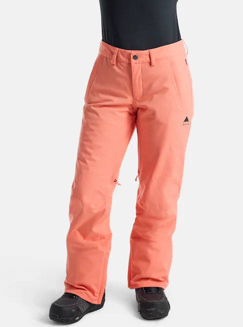 A pair of women's Burton Society 2L snow pants in an orange color, featuring a regular fit with a higher-rise waist, zippered handwarmer pockets, and a design suitable for cold weather riding.