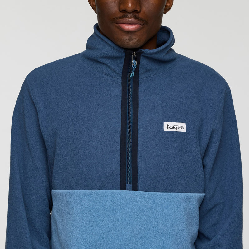 Load image into Gallery viewer, Person wearing a blue pullover with a brand logo on a gray background
