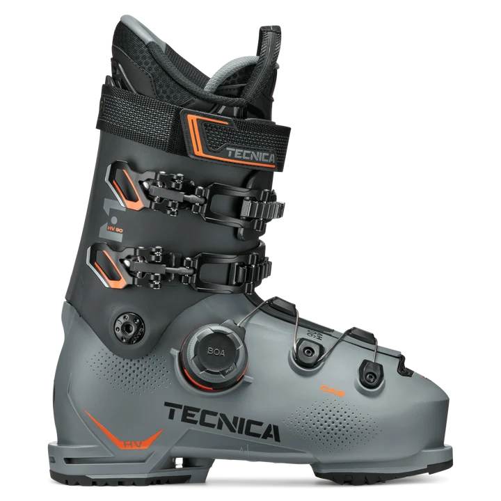 Load image into Gallery viewer, A single Tecnica ski boot in dark gray and black with bright orange accents, featuring dual quick-release buckles and a BOA dial system, shown on a clean white background. Ski and Tennis Station
