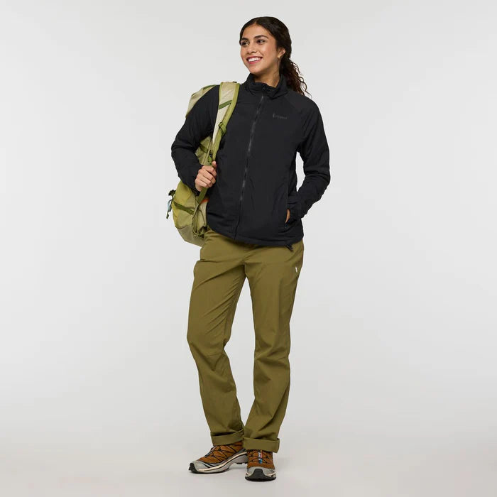 Load image into Gallery viewer, Woman wearing a black jacket and green pants holding a green backpack on a white background
