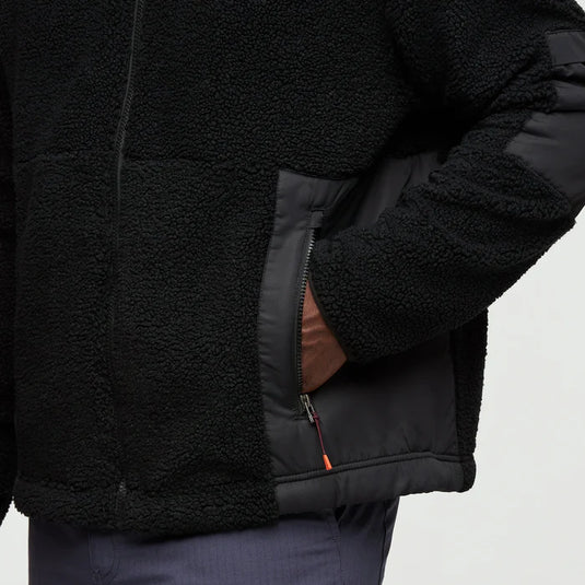 Close-up of a black fleece jacket with a gray interior on a white background