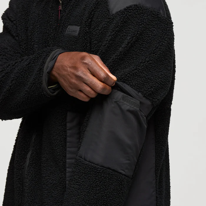 Load image into Gallery viewer, Black fleece jacket with a pocket on a light gray background
