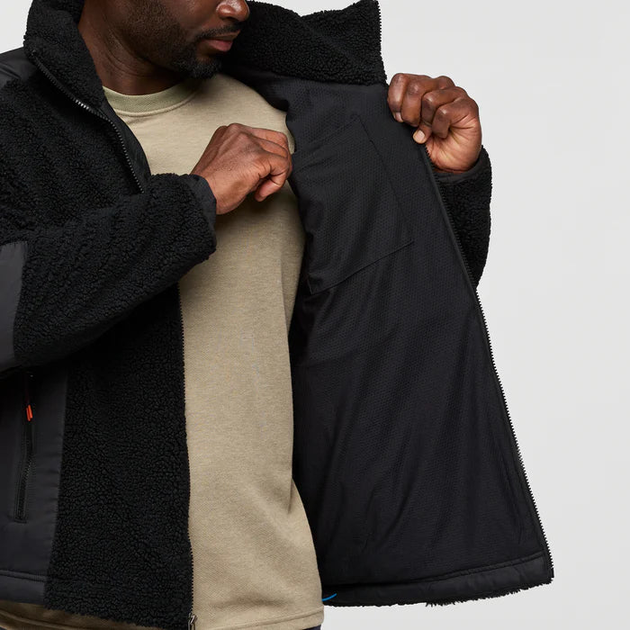 Load image into Gallery viewer, Person wearing a black jacket with a textured inner lining, holding it open to show the interior.
