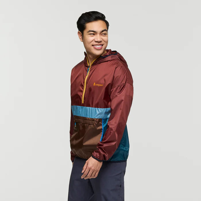 Load image into Gallery viewer, Man wearing a multicolored jacket with a visible brand logo on a light gray background
