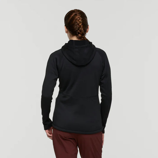Person wearing a black hoodie and maroon pants on a light gray background