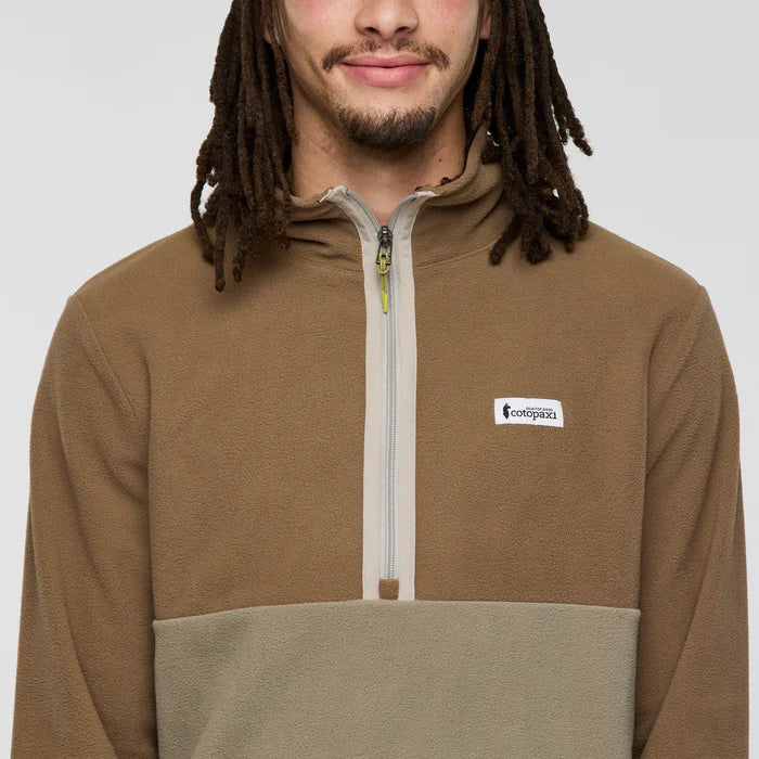 Load image into Gallery viewer, Man wearing a brown and beige pullover with a cotopaxi logo on a white background
