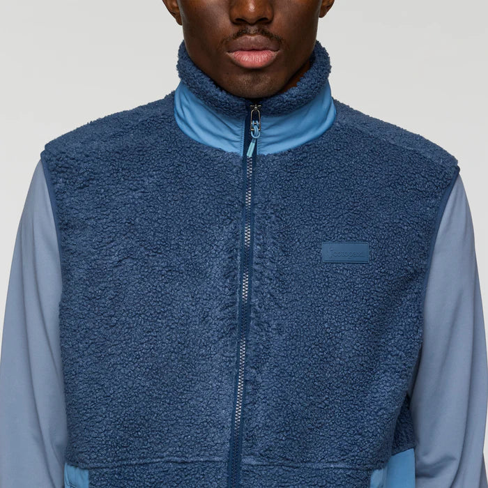 Load image into Gallery viewer, Person wearing a blue fleece vest over a light blue shirt on a plain background
