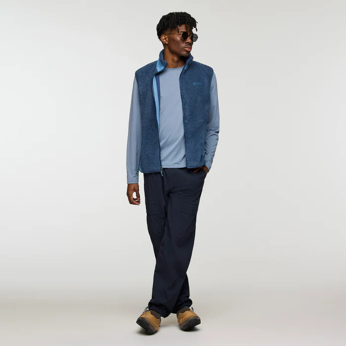Load image into Gallery viewer, Man wearing a blue vest over a light blue shirt with dark pants on a white background
