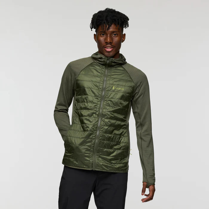 Load image into Gallery viewer, Person wearing a green jacket with a brand logo on a gray background
