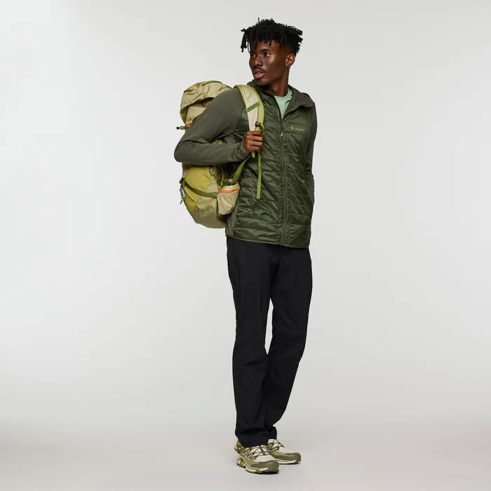 Load image into Gallery viewer, Man wearing a green jacket and black pants with a green backpack on a white background
