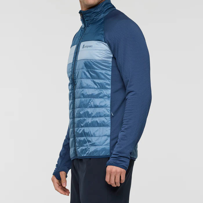 Load image into Gallery viewer, Blue puffer jacket with a visible brand logo on a white background
