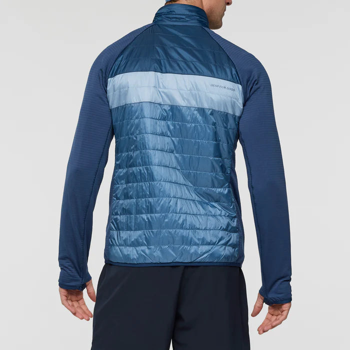 Load image into Gallery viewer, Blue puffer jacket on a light gray background
