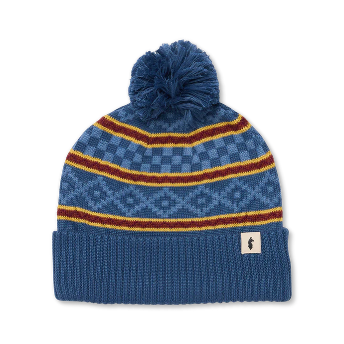 Blue knit beanie with pom-pom and colorful stripes on a white background