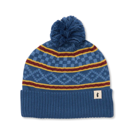 Blue knit beanie with pom-pom and colorful stripes on a white background