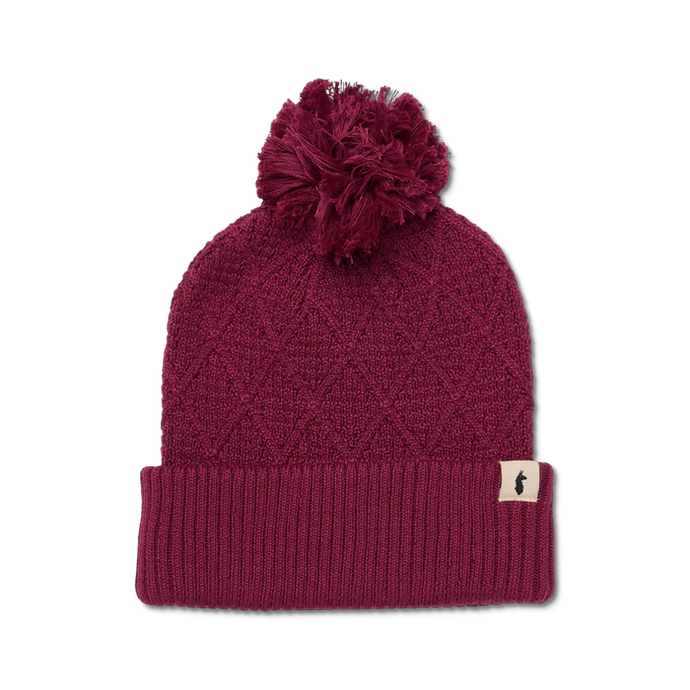 Maroon knit beanie with pom-pom on a white background