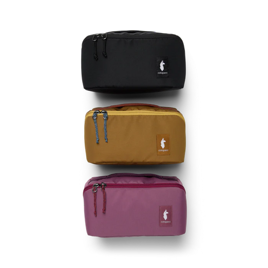 Three travel bags in black, brown, and purple on a white background