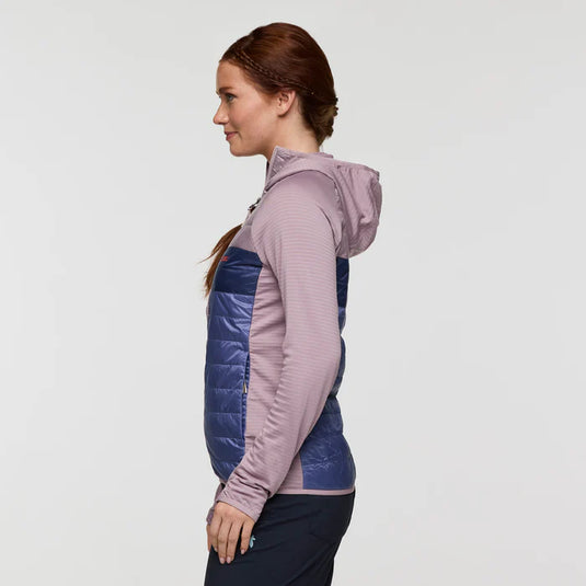 Woman wearing a two-tone jacket with purple and blue colors on a light gray background