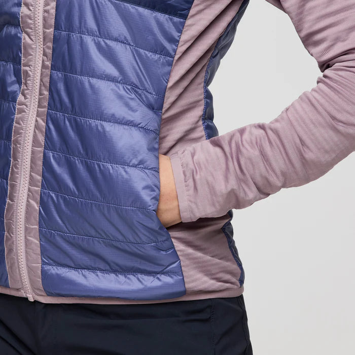 Load image into Gallery viewer, Close-up of a person wearing a blue and pink quilted jacket on a light gray background
