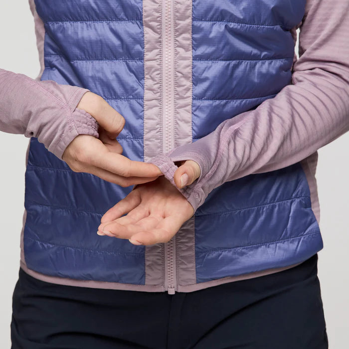 Load image into Gallery viewer, Person wearing a blue and pink quilted jacket with hands clasped together.
