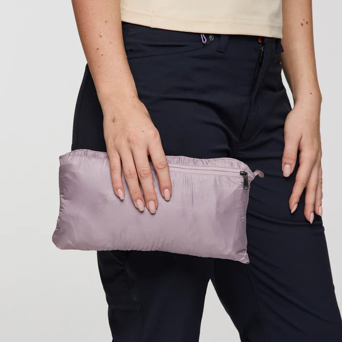 Load image into Gallery viewer, Person holding a purple compact bag against a neutral background
