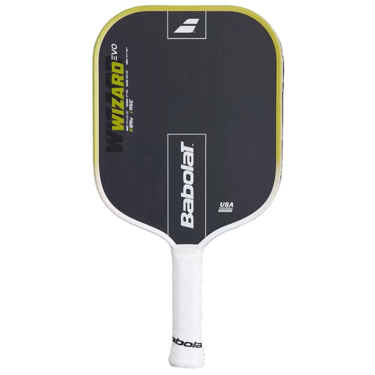 A Babolat Wizard EVO pickleball paddle shown vertically against a solid black background. The paddle features a dark gray face with a yellow border, white Babolat branding, and a white handle grip. Ski & Tennis Station