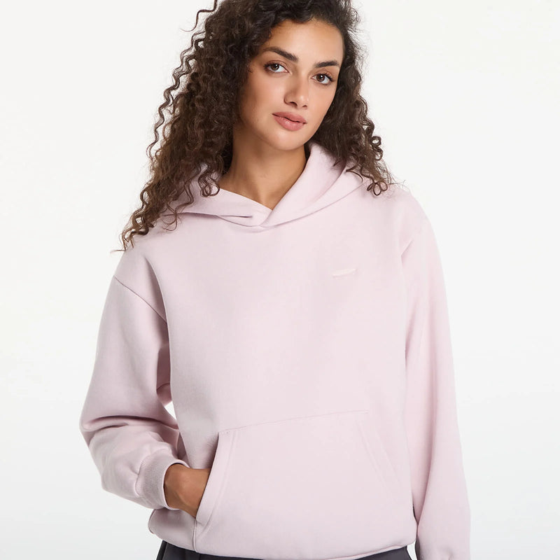 Load image into Gallery viewer, A woman with curly brown hair wearing a light pink pullover hoodie with a small tonal Vans skateboard logo. Ski and Tennis Station
