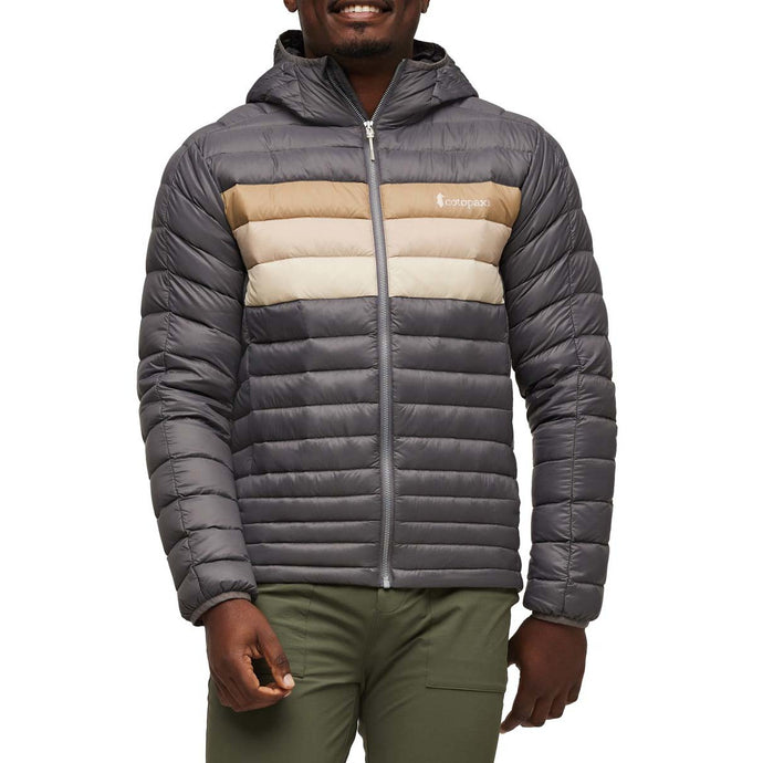 Person wearing a gray puffer jacket with a Cotopaxi logo on a white background