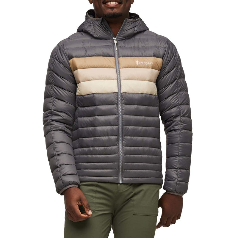 Load image into Gallery viewer, Person wearing a gray puffer jacket with a Cotopaxi logo on a white background
