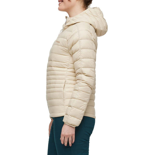 Beige puffer jacket worn by a person on a white background