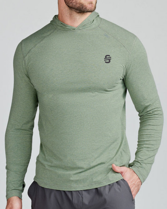 Person wearing a green long-sleeve athletic shirt with a logo on a gray background