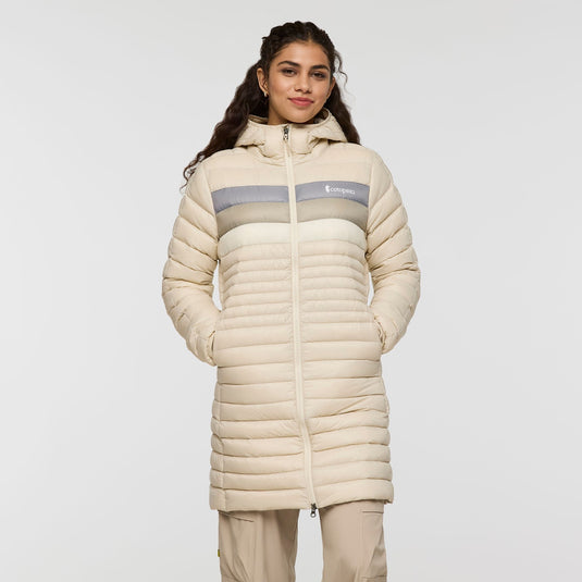 Woman wearing a beige puffer coat with a visible brand logo on a white background