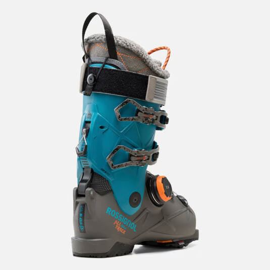 Load image into Gallery viewer, A Rossignol All Mountain ski boot in teal blue and gray with black straps and orange accents, shown from a side profile on a light gray background.
