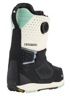 Black and white snowboarding boot with green accents on a white background.