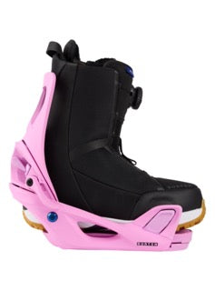 Black snowboarding boot in a pink binding on a white background