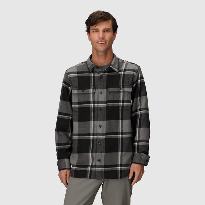 Man wearing a black and gray plaid shirt on a white background