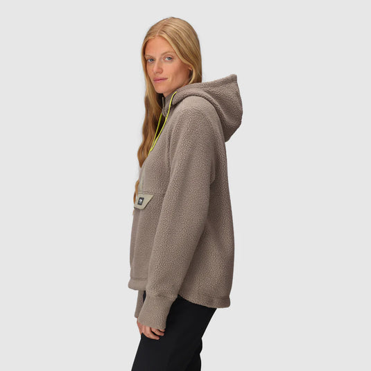 Woman wearing a brown hoodie on a light gray background