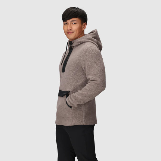 Man wearing a beige fleece jacket on a light gray background