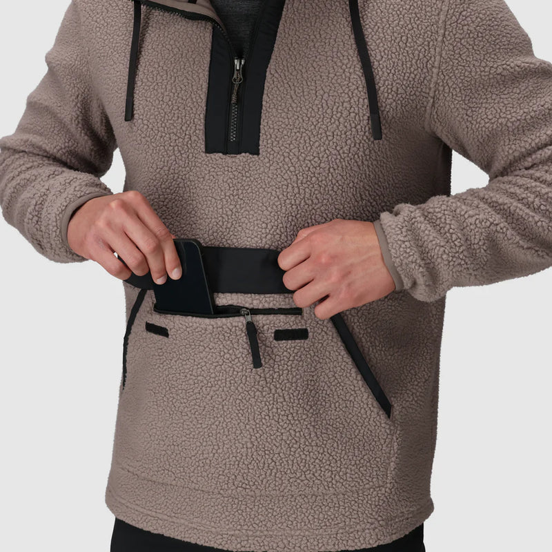 Load image into Gallery viewer, Person wearing a brown fleece pullover with a phone in a pocket on a light gray background
