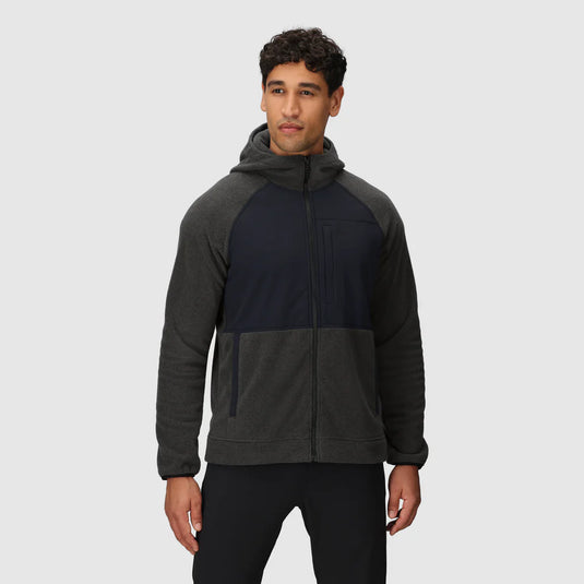 Man wearing a two-tone jacket with a gray hood and black body on a white background