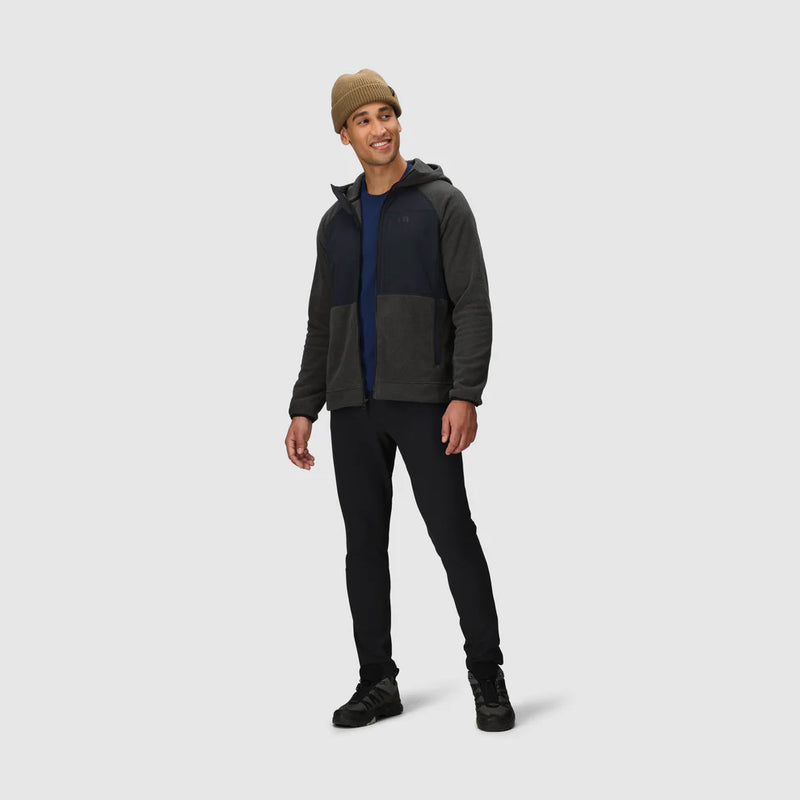 Load image into Gallery viewer, Man wearing a dark gray hoodie with a navy shirt underneath, black pants, and a brown beanie on a white background.
