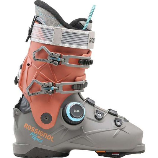 A Rossignol alltrack 90 men's ski boot in a gray and coral orange colorway, featuring a dial closure system and multiple buckles, shown against a plain white background. Ski and Tennis Station