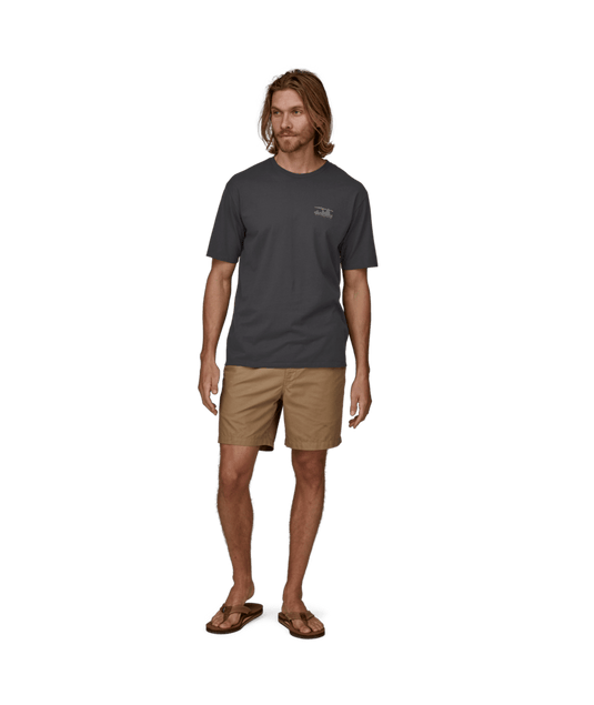 Man wearing a dark gray t-shirt and beige shorts on a transparent background