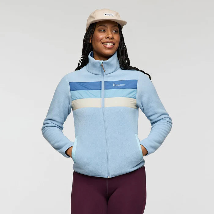 Load image into Gallery viewer, Woman wearing a light blue fleece jacket with a Cotopaxi logo on a plain background
