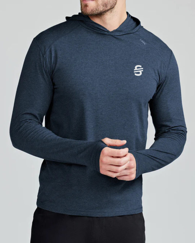 Load image into Gallery viewer, Man wearing a navy blue hoodie with a logo on a gray background
