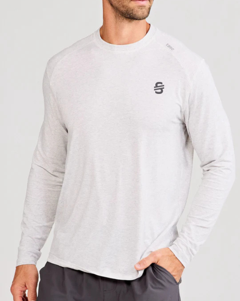 Load image into Gallery viewer, Man wearing an off-white long-sleeve shirt with a logo on a white background
