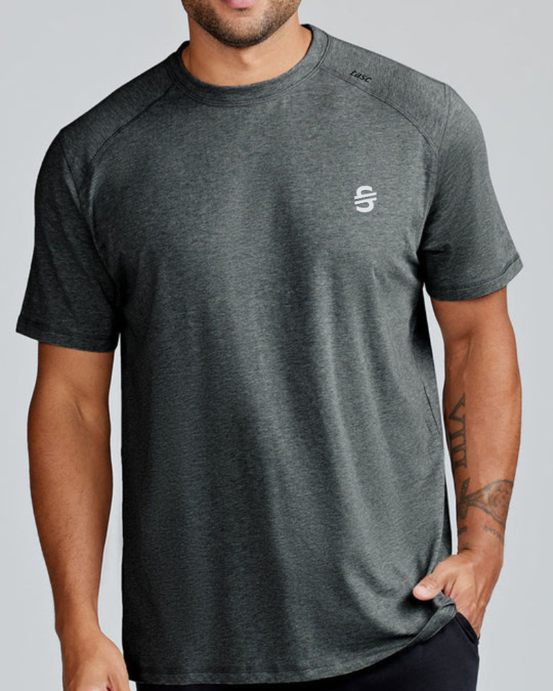 Load image into Gallery viewer, Man wearing a dark gray t-shirt with a small logo on a plain background
