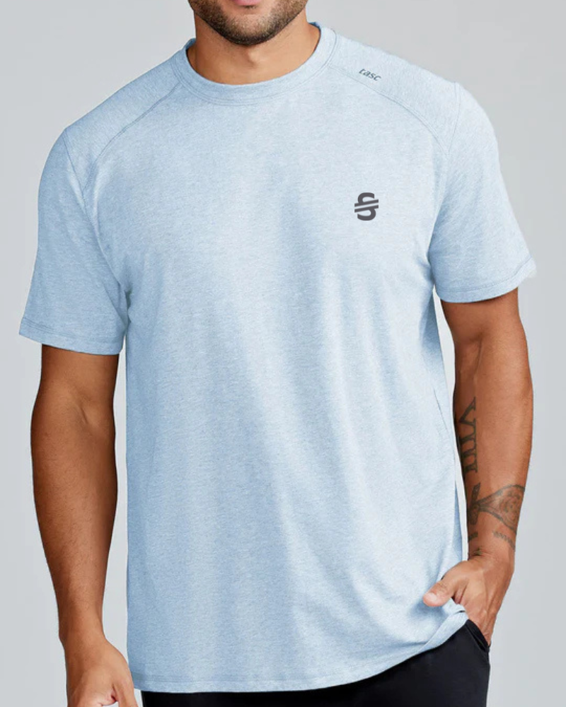 Load image into Gallery viewer, Person wearing a light blue t-shirt with a logo on a gray background
