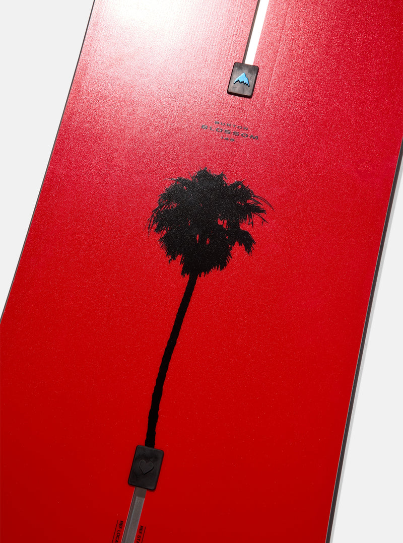 Load image into Gallery viewer, Red snowboard with black palm tree silhouette and mountain logo.
