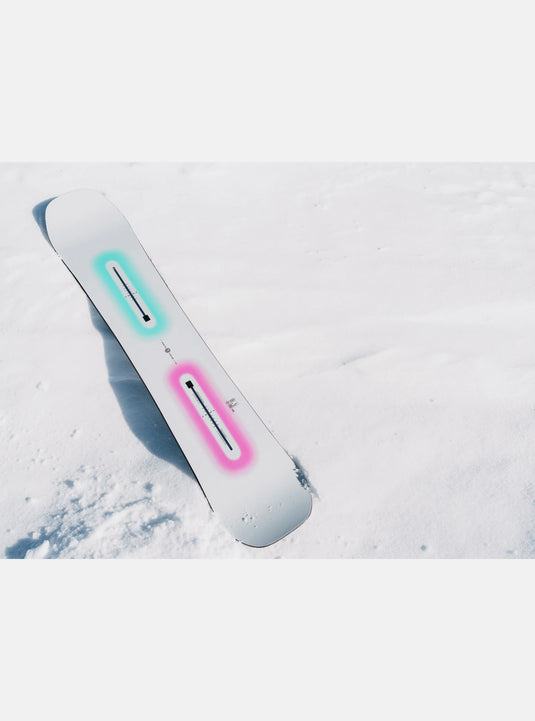 Snowboard with colorful accents on a snow-covered surface